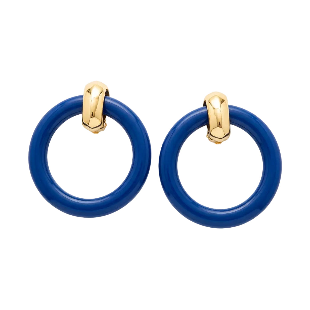 A pair of large glossy blue hoop earrings with polished gold-tone metal connectors, displayed on a beige backing card against a light gray background.