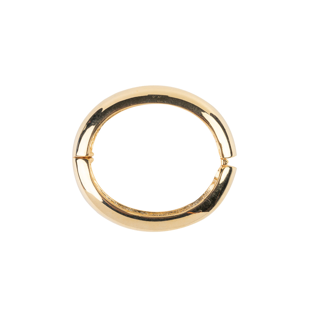 Kenneth Jay Lane 1/2-Wide Polished Gold Hinged Bracelet. A gold bracelet with a 1/2-inch wide band that is polished to a high shine.