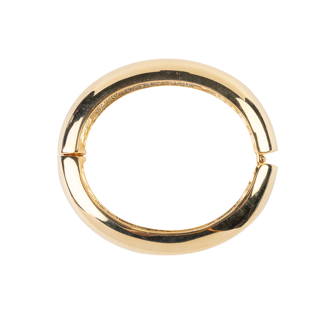 Kenneth Jay Lane 1/2-Wide Polished Gold Hinged Bracelet. A gold bracelet with a 1/2-inch wide band that is polished to a high shine.