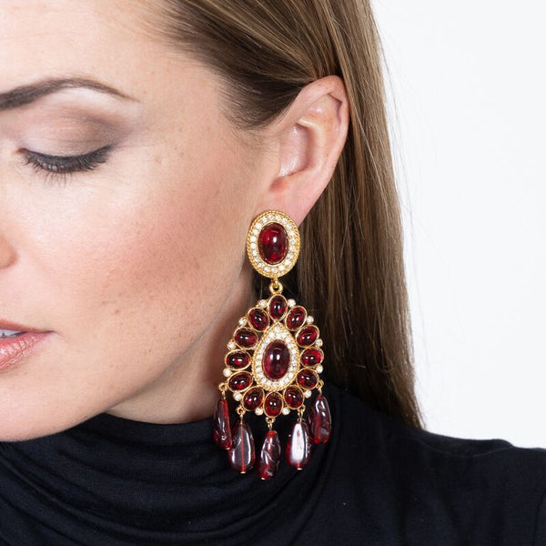 Gold Ruby Drop Clip Earrings by Kenneth Jay Lane Luxurious gold ruby drop clip earrings Ruby inspired earrings Ruby cabochons in a gold setting Perfect for any outfit A must-have for any jewelry collection Shop these ruby drop clip earrings today and add a touch of luxury to your look